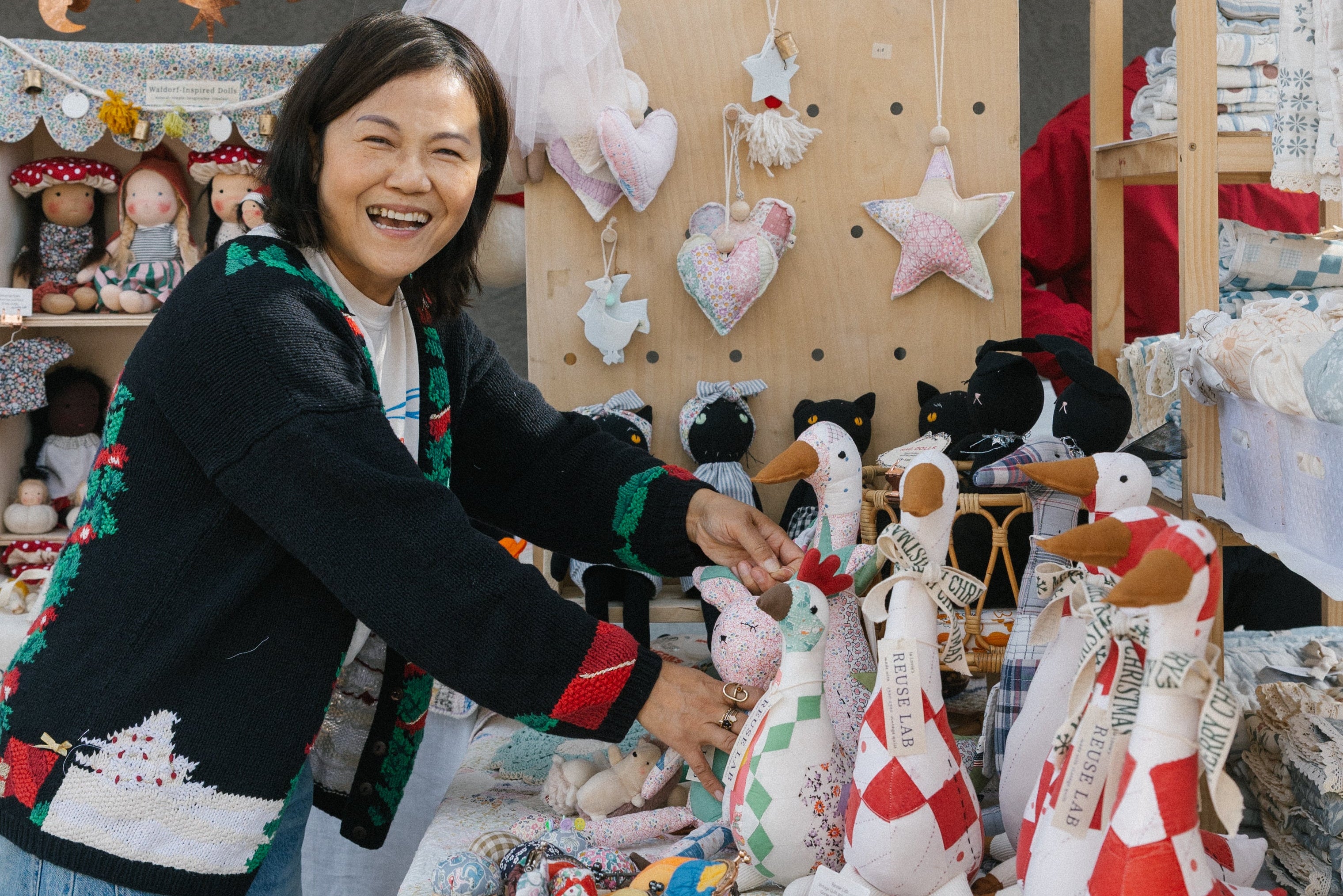 Woman at a craft fair with handmade items on display