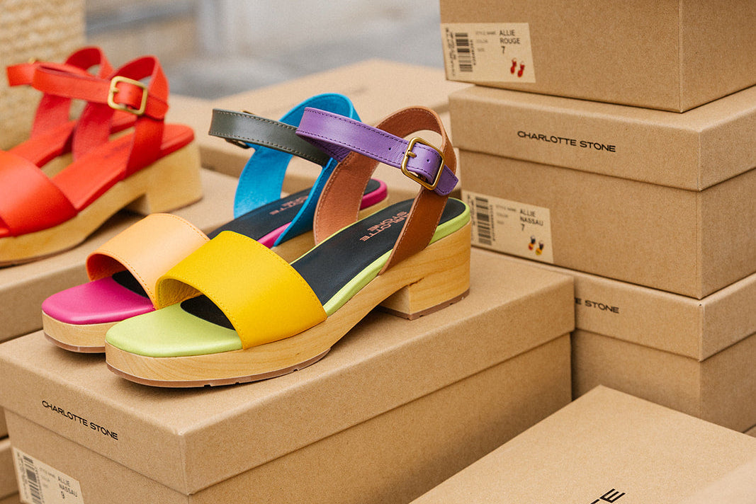 Colorful sandals on top of Charlotte stone shoe boxes